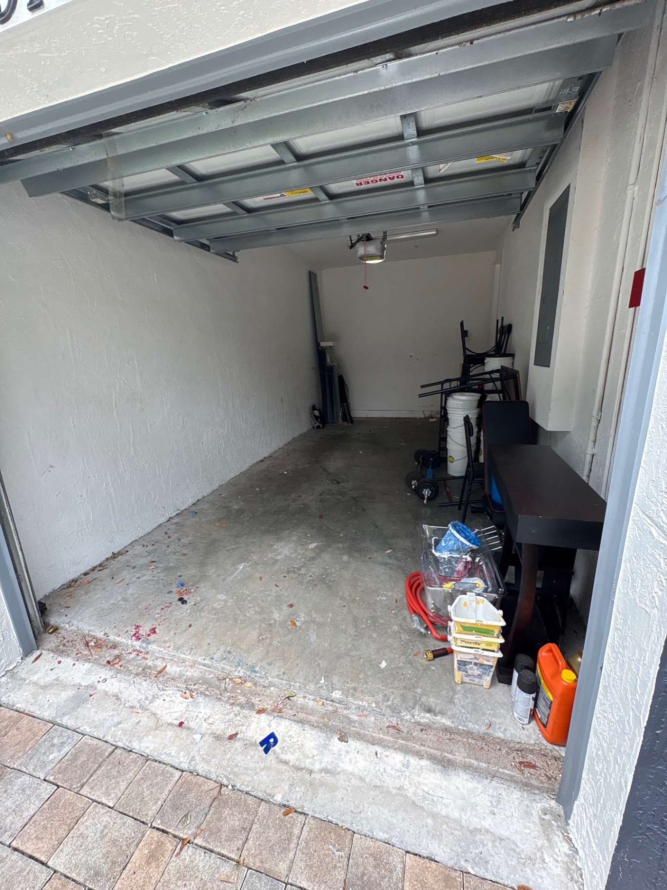 Garage after bulky items were removed, with supplies remaining